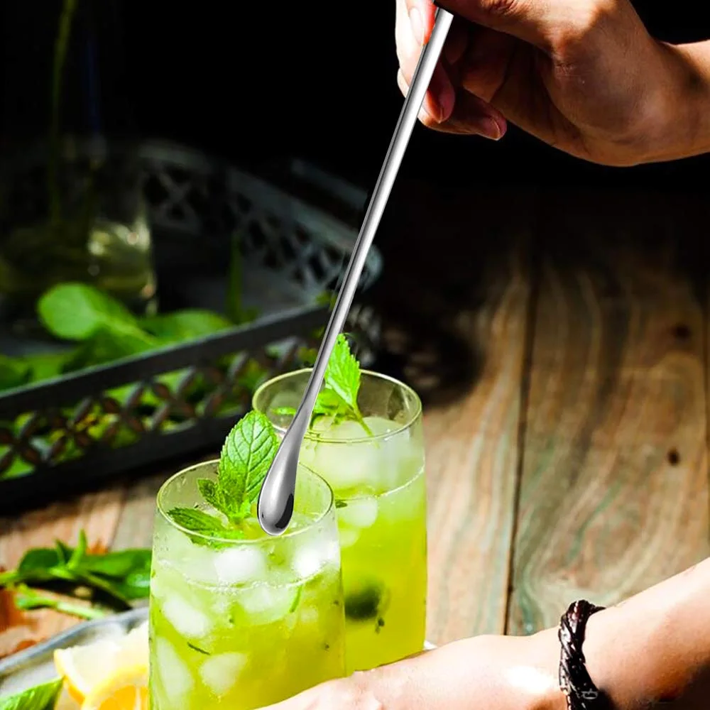 Stirring a green drink with mint in a tall glass with a long Delove spoon.